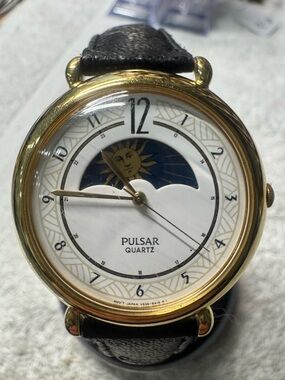 Pulsar Gold Tone Watch with White Dial and Black Strap